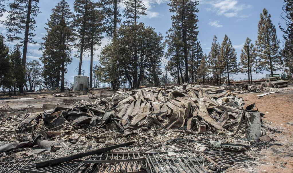 The remains of a burned home lie in the Foresta community in Yosemite National Park in California on Tuesday, July 29, 2014. (AP Photo/Al Golub)