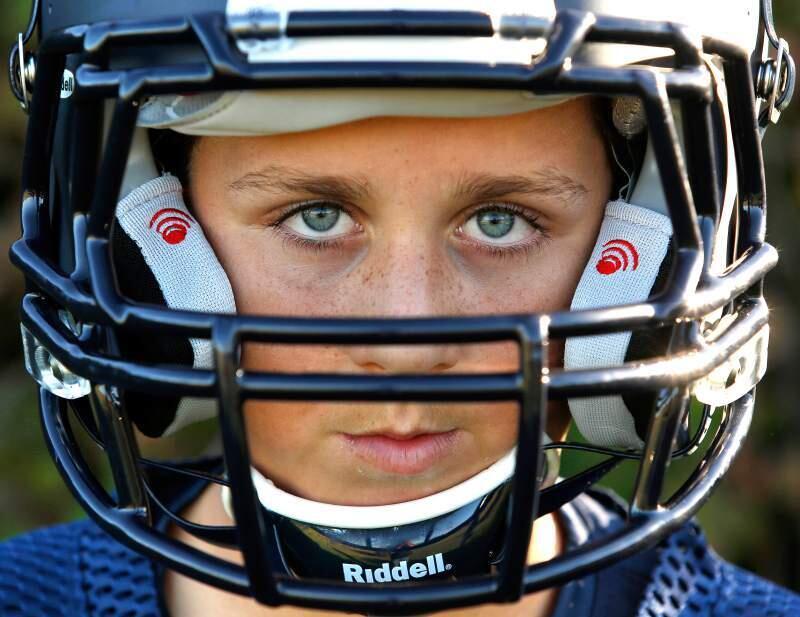 Petaluma Panthers' Dominic Feliciano, 12, wears a football helmet equipped with the Riddell InSite impact monitoring system, distinguised by the red icons on the cheek pads. (Alvin Jornada).
