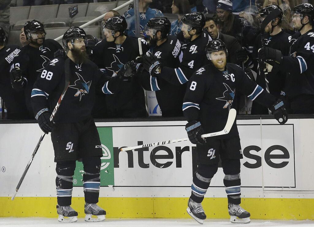 San Jose Sharks center Joe Pavelski (8) and defenseman Brent Burns (88) celebrate with teammates after Pavelski's goal during the second period against the Nashville Predators in San Jose, Saturday, Oct. 29, 2016. The Sharks won 4-1. (AP Photo/Jeff Chiu)