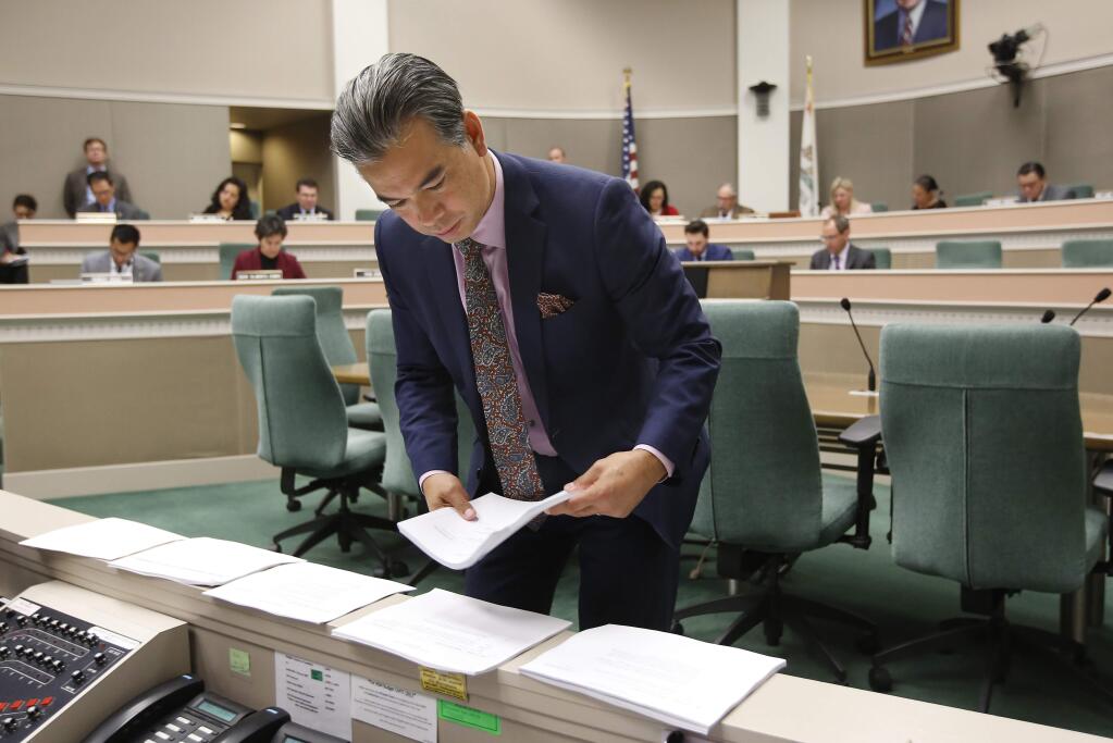 Assemblyman Rob Bonta, D- Alameda, looks over various bills before the Assembly Appropriations Committee, Thursday, May 16, 2019, in Sacramento, Calif. The committee failed to advance Bonta's measure to temporarily lower taxes on marijuana products in California. (AP Photo/Rich Pedroncelli)