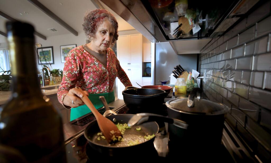 Marlena Hirsch cooks dinner in her Mark West Springs area home on Monday, Sept. 16, 2019. (KENT PORTER/ PD)
