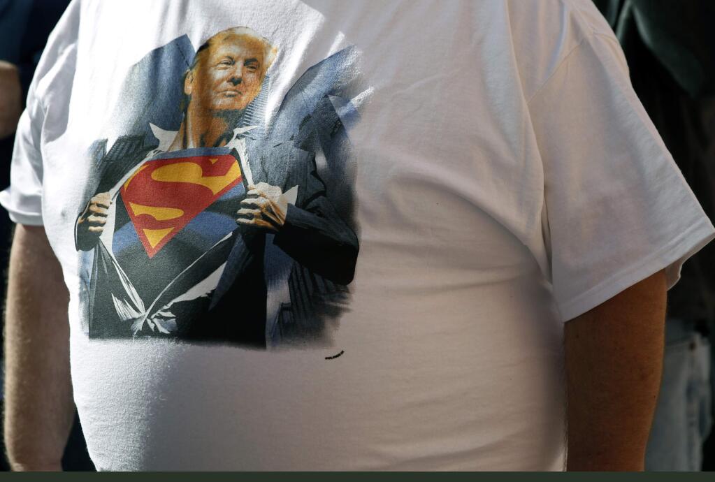 A supporter wears a Donald Trump shirt as he waits in line for an April 16, 2016 campaign rally in Syracuse, New York. (MEL EVANS / Associated Press)