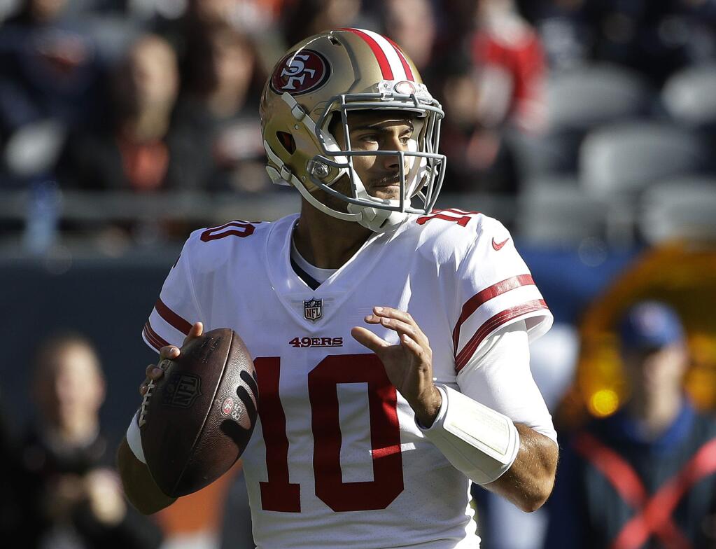San Francisco 49ers quarterback Jimmy Garoppolo (10) looks for a receiver during the first half of an NFL football game against the Chicago Bears, Sunday, Dec. 3, 2017, in Chicago. (AP Photo/Nam Y. Huh)