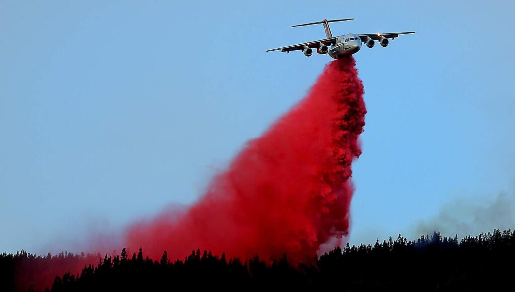 An air tanker paints a ridge between the Elk fire and unburned forest in Upper Lake, Wednesday Sept. 2, 2015. (Kent Porter / Press Democrat) 2015