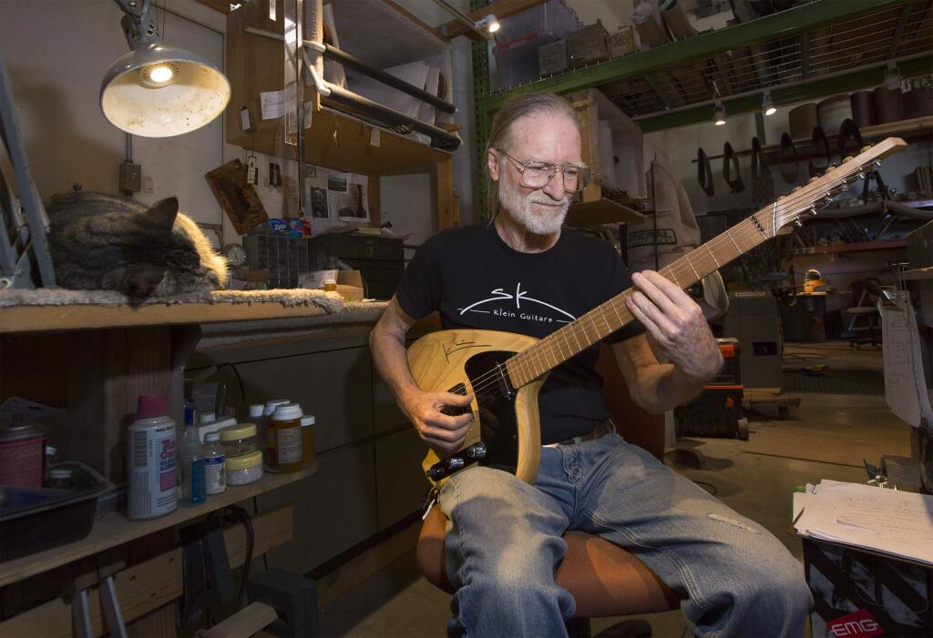 Luthier (maker of stringed instruments) Steve Klein specializes in guitars, and has done for the past fifty years. Here, in his workshop, he plucks at one of his steel guitars. (Photo by Robbi Pengelly/Index-Tribune)