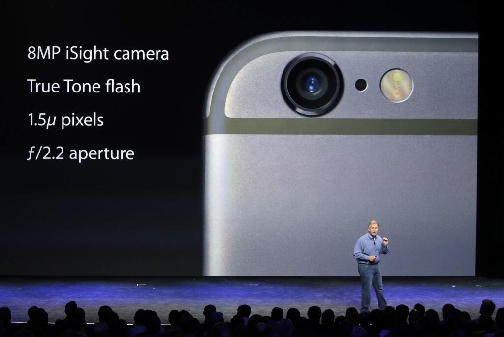 Phil Schiller, Apple's senior vice president of worldwide product marketing, discusses the camera features on the new iPhone 6 and iPhone 6 plus on Tuesday, Sept. 9, 2014, in Cupertino, Calif. (AP Photo/Marcio Jose Sanchez)