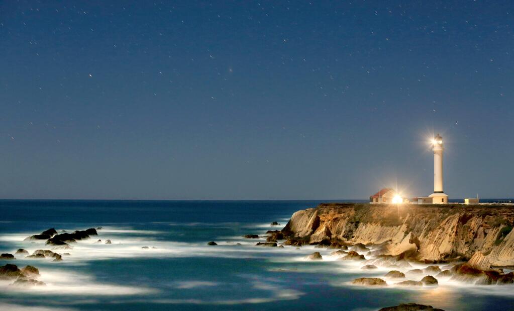 The Point Arena Lighthouse is bathed in moonlight under a starry night, Tuesday March 11, 2014. (Kent Porter / Press Democrat)