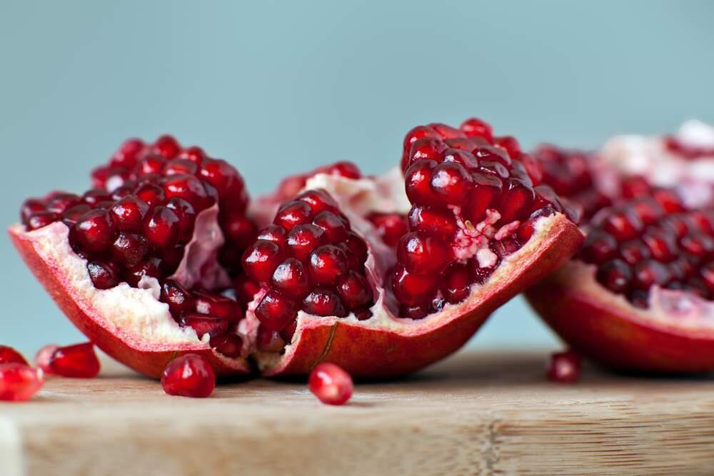 Start peeling your pomegranate by cutting it through the middle rather than end to end.