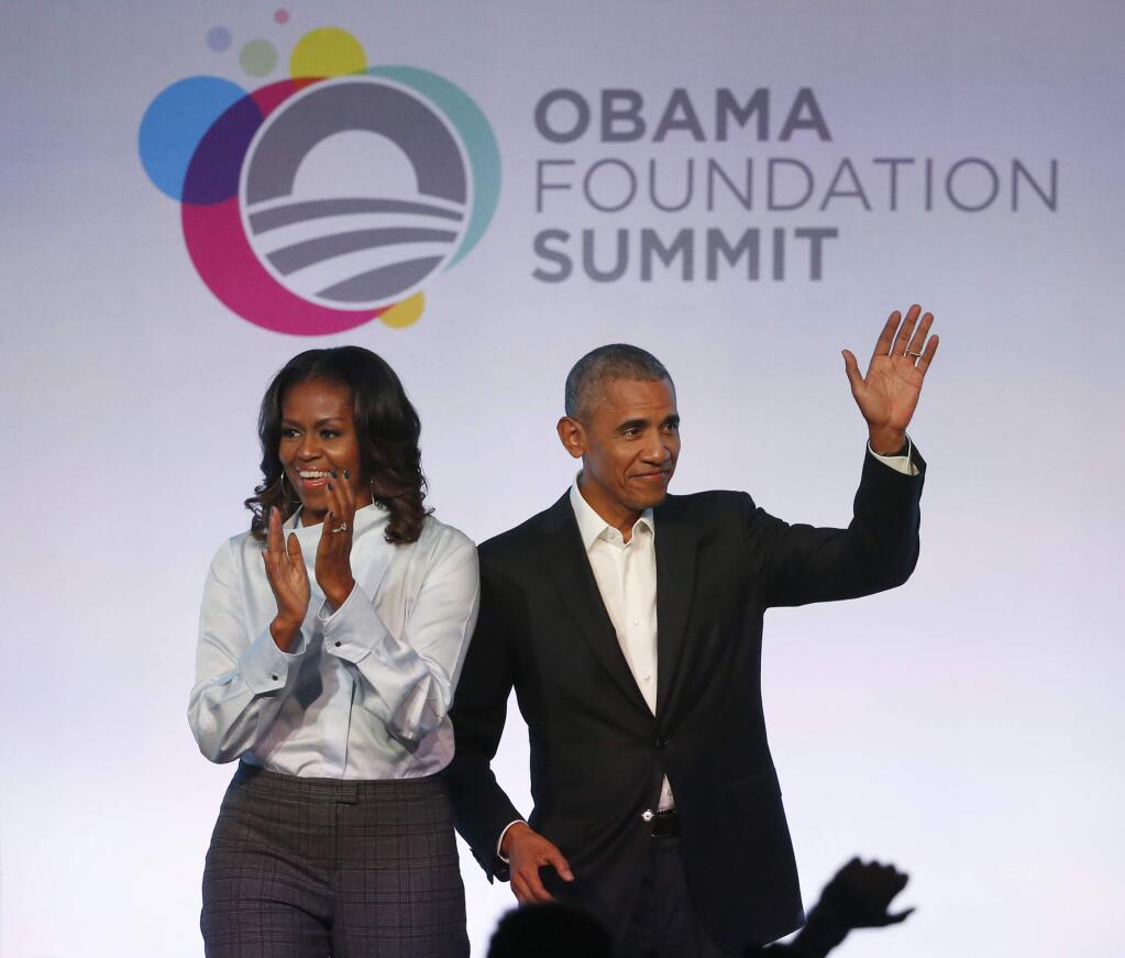 FILE - In this Oct. 13, 2017 file photo, former President Barack Obama, right, and former first lady Michelle Obama arrive for the first session of the Obama Foundation Summit in Chicago. (AP Photo/Charles Rex Arbogast, File)