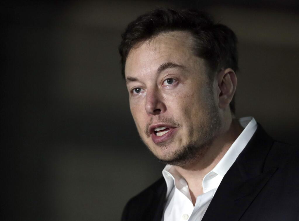FILE - In a Thursday, June 14, 2018 file photo, Tesla CEO and founder of the Boring Company Elon Musk speaks at a news conference, in Chicago. Whether it's investors betting against his stock, reporters or analysts who ask tough questions or a union trying to organize his workers, Elon Musk has fought back, often around the clock on Twitter. But when Musk called a British diver involved in the Thailand cave rescue a pedophile to 22.3 million Twitter followers on July 15, he may have gone one tweet too far. (AP Photo/Kiichiro Sato, File)