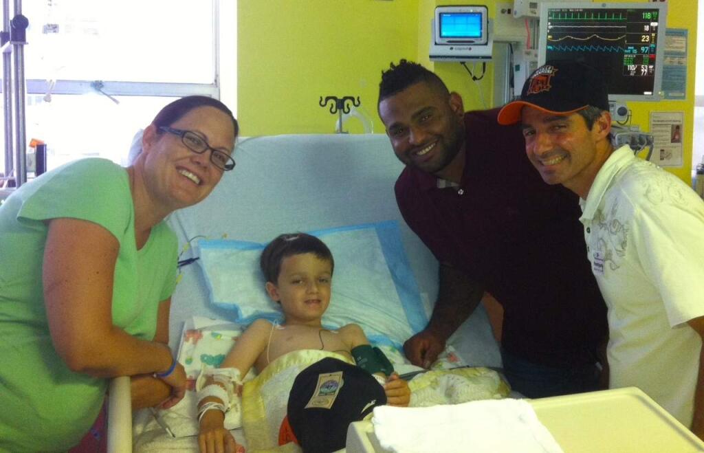 Isaac Smith with Pablo Sandoval and his parents, Lisa and Phillip Smith. (COURTESY PHOTO)