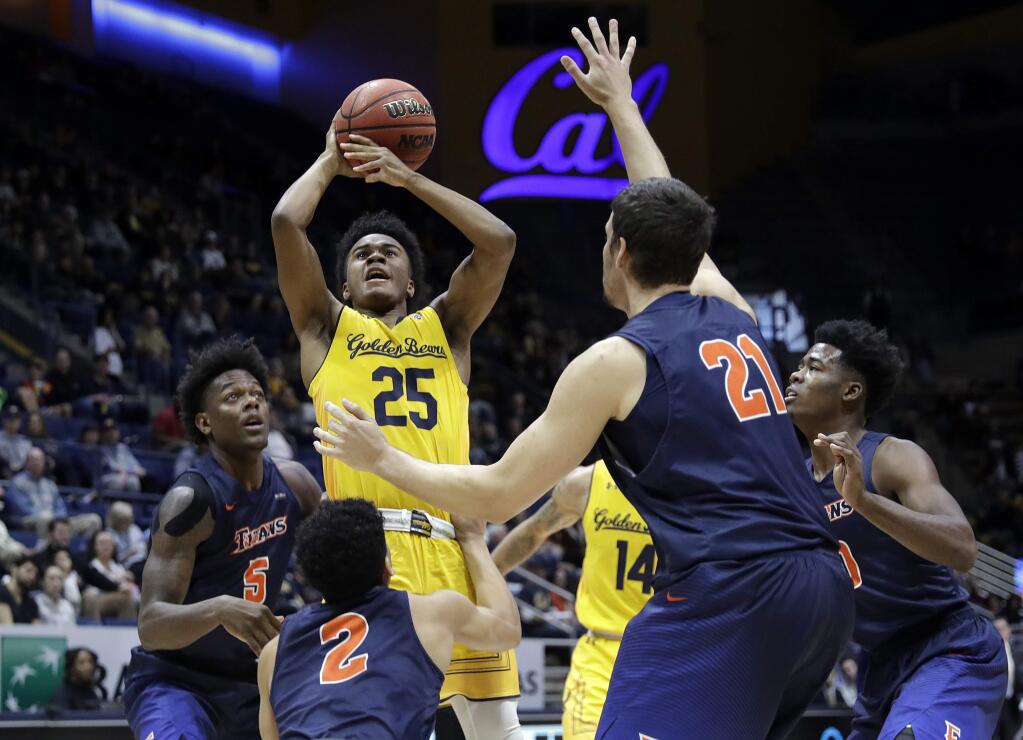 California guard Deschon Winston (25) grabs a rebound while surrounded by Cal State Fullerton players during the first half Saturday, Dec. 16, 2017, in Berkeley. (AP Photo/Marcio Jose Sanchez)