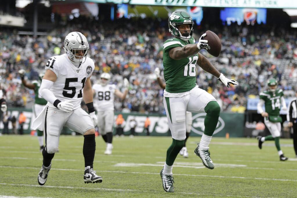 New York Jets wide receiver Demaryius Thomas, right, runs away from Oakland Raiders inside linebacker Will Compton during the first half, Sunday, Nov. 24, 2019, in East Rutherford, N.J. (AP Photo/Adam Hunger)
