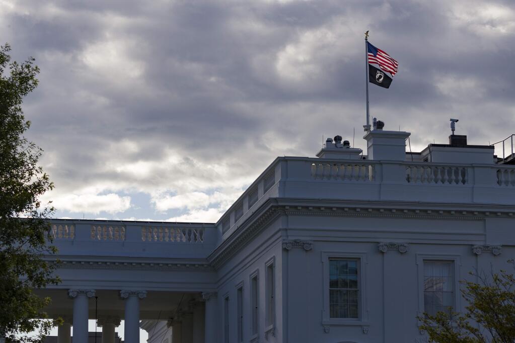 The U.S. flag and the POW-MIA flag fly over the White House on Flag Day, Friday, June 14, 2019, in Washington. (AP Photo/Alex Brandon)