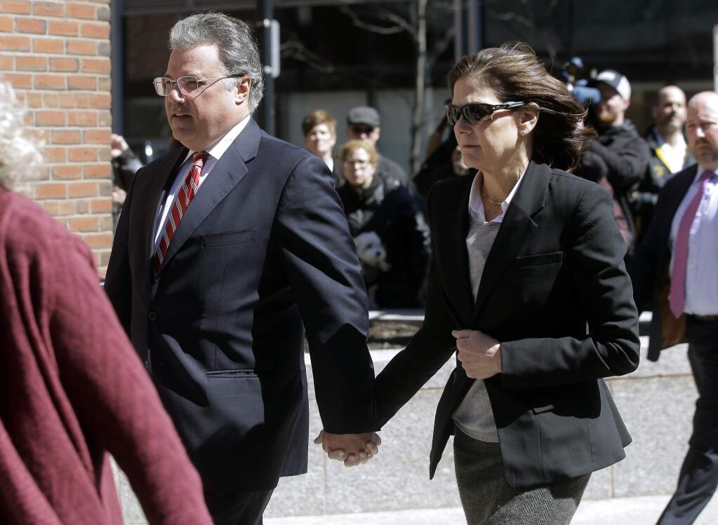 FILE - In this April 3, 2019, file photo, Manuel and Elizabeth Henriquez arrive at federal court in Boston to face charges in a nationwide college admissions bribery scandal. The couple are scheduled to plead guilty on Monday, Oct. 21. (AP Photo/Steven Senne, File)