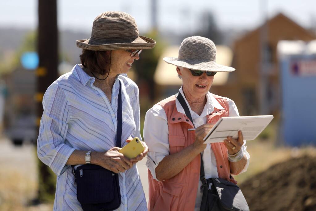 Susan Cornelis, left, and Bettina Armstrong, who are with a group who call themselves 'urban sketchers', talk while taking a break from working on watercolors of construction underway on Brandee Lane in Santa Rosa on Thursday, June 28, 2018. (Beth Schlanker/ The Press Democrat)