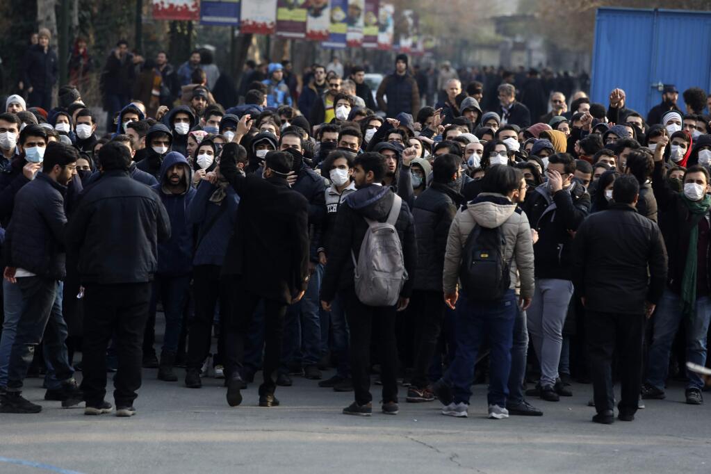 Anti-government protesters attend a demonstration blaming the government for the delayed announcement of the unintentional downing of a Ukrainian plane last week, at the Tehran University campus in Tehran, Iran, Tuesday, Jan. 14, 2020. Anti-government protesters are angered by the late announcement of the mistake by officials and military, saying an apology is not enough and all those responsible must be held accountable. Pro-government protesters say the Revolutionary Guard should not be undermined for this mistake and accuse foreign powers of stirring up unrest in the country. (AP Photo/Vahid Salemi)
