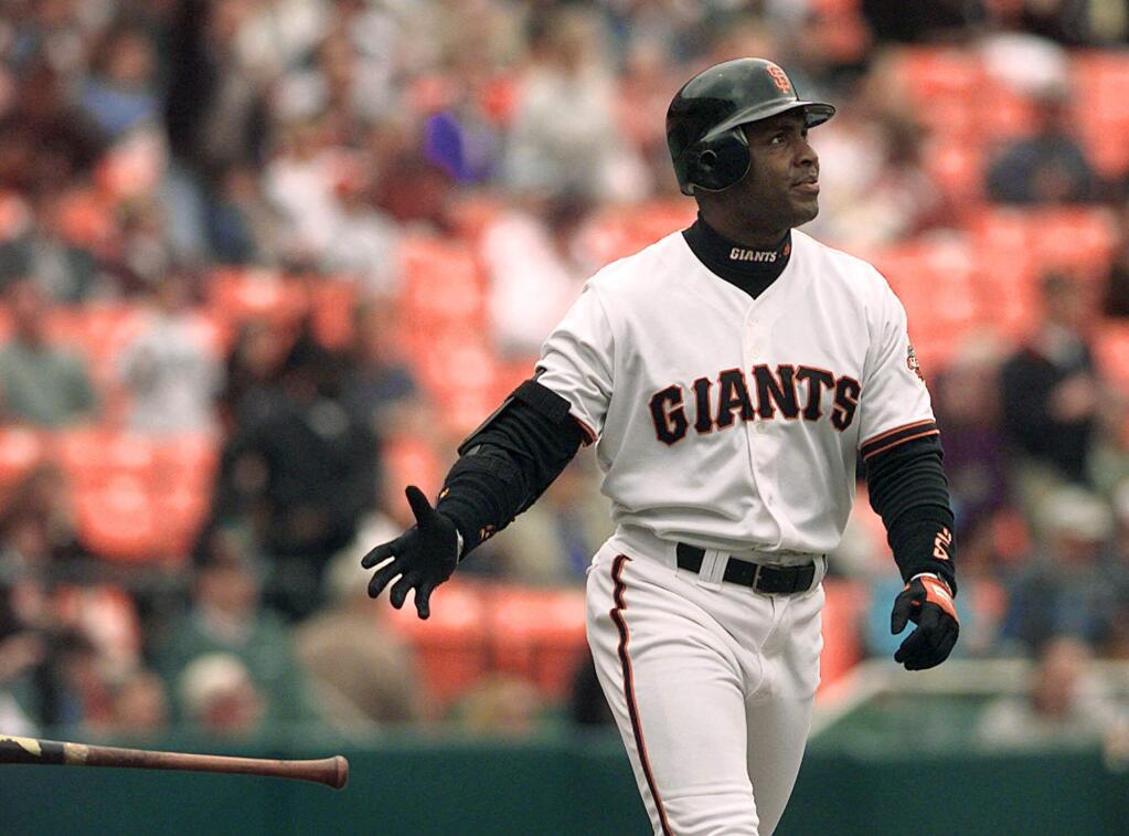 In this Aug. 18, 1999, file photo, San Francisco Giants' Barry Bonds tosses his bat after hitting a two-run home run off Montreal Expos' Javier Vazquez in the first inning of a game at Candlestick Park in San Francisco. (AP Photo/Ben Margot/File)