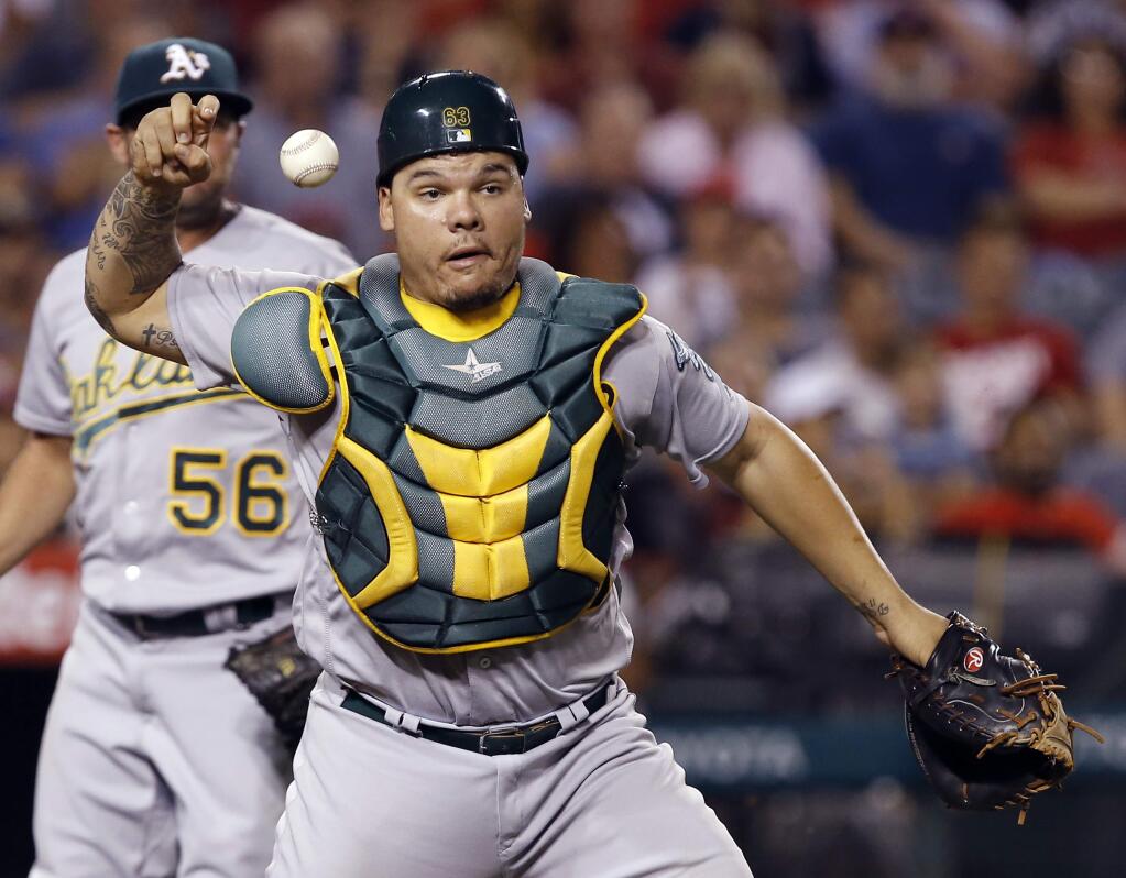 Oakland Athletics catcher Bruce Maxwell loses his grip on the ball while trying to throw out Los Angeles Angels' Jeff Bandy during the fourth inning Wednesday, Sept. 28, 2016. Maxwell was charged with an error. (AP Photo/Alex Gallardo)