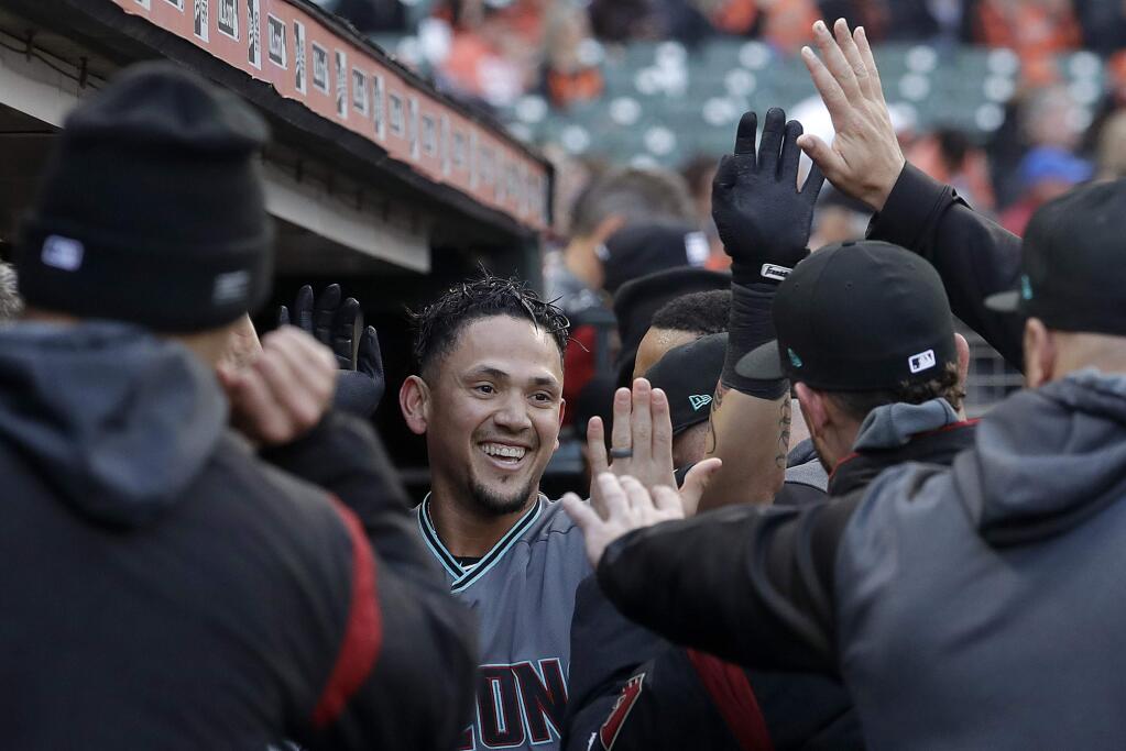 Arizona Diamondbacks' Ildemaro Vargas, center, is congratulated by teammates after hitting a solo home run against the San Francisco Giants during the first inning of a baseball game in San Francisco, Friday, May 24, 2019. (AP Photo/Jeff Chiu)