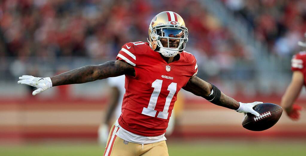 Marquise Goodwin celebrates a first-down pass reception against the Titans, Sunday Dec. 17, 2017 in Santa Clara. (Kent Porter / The Press Democrat)