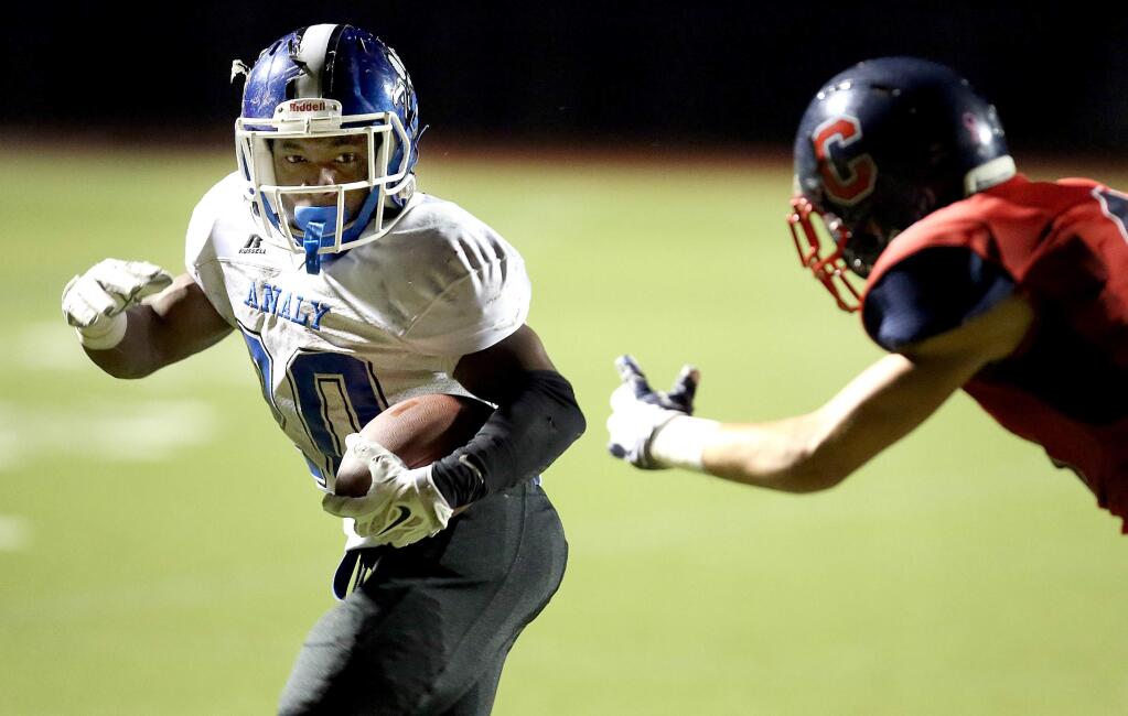 Analy's Ja'narrick James runs the ball in for a touchdown as Campolindo's Devin Regan struggles to catch him during the game held at Campolindo High School, Friday, November 28, 2014. (Crista Jeremiason/The Press Democrat)