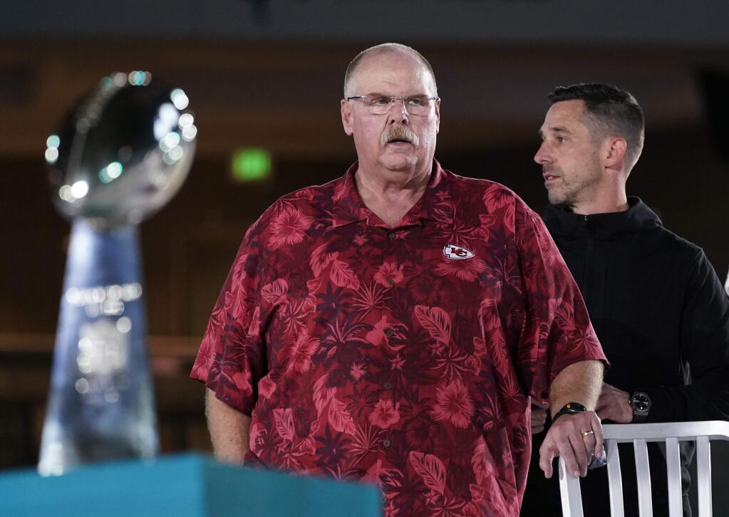 Kansas City Chiefs coach Andy Reid, left, stands next to San Francisco 49ers coach Kyle Shanahan during opening night for the Super Bowl LIV Monday, Jan. 27, 2020, at Marlins Park in Miami. (AP Photo/David J. Phillip)