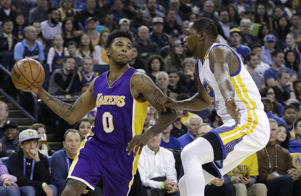 Los Angeles Lakers' Nick Young (0) looks to pass as Golden State Warriors' Kevin Durant defends during the first half of an NBA basketball game, Wednesday, Nov. 23, 2016, in Oakland, Calif. (AP Photo/Marcio Jose Sanchez)