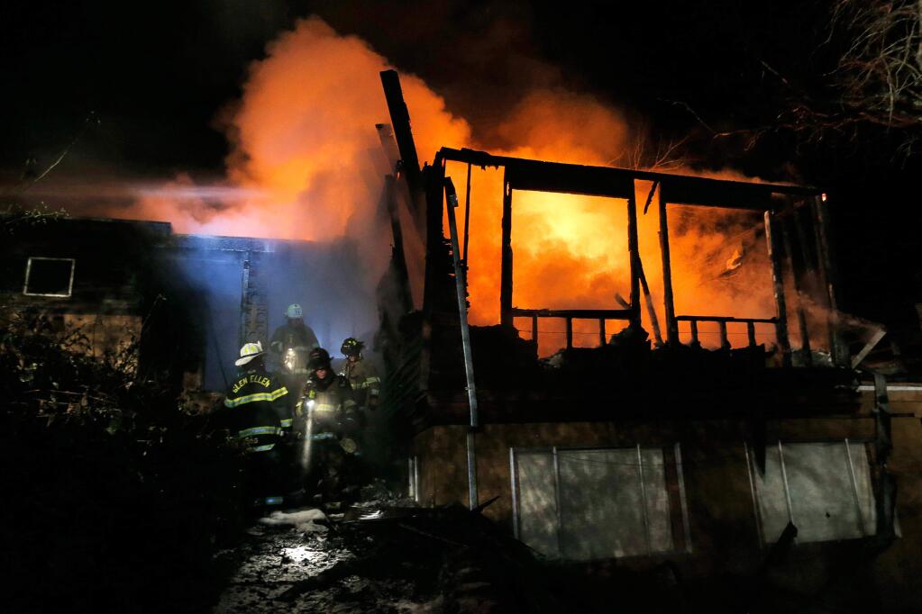 Kenwood, Glen Ellen and Rincon Valley firefighters respond to a house fire off Lawndale Road in Kenwood, California on Friday, January 13, 2017. (Alvin Jornada / The Press Democrat)