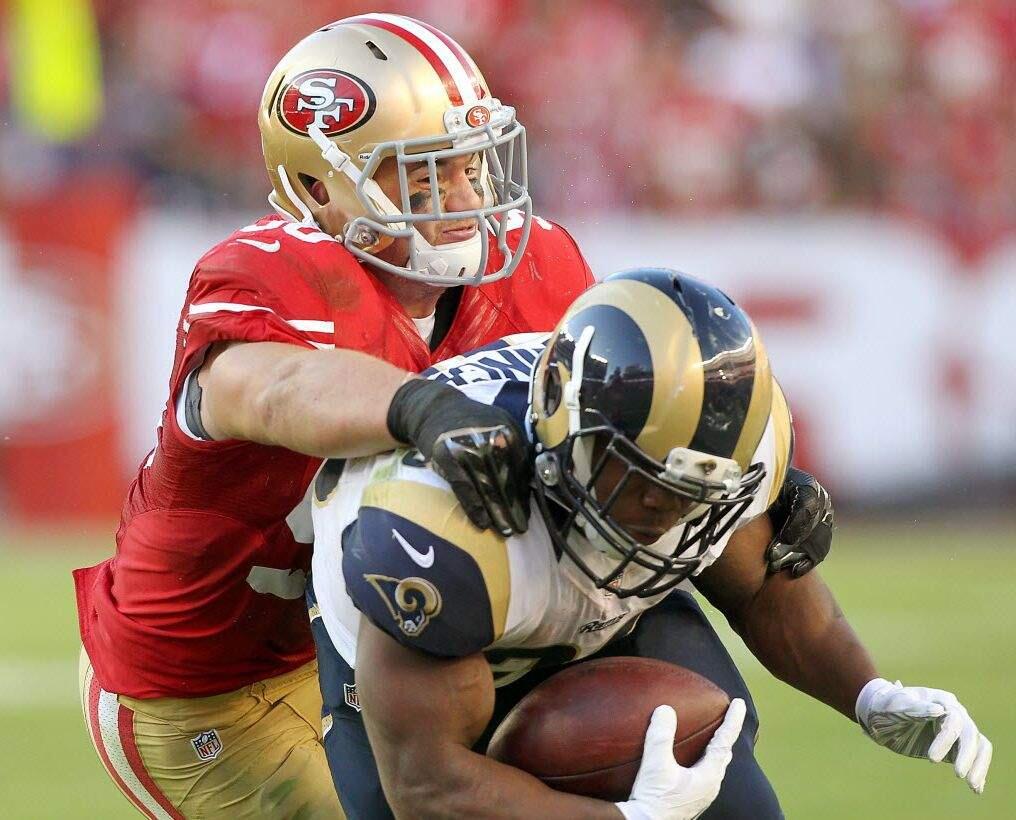 49ers linebacker Chris Borland pulls down Chase Reynolds of the St. Louis Rams in the fourth quarter of their game at Santa Clara on Nov. 2. (John Burgess / The Press Democrat)