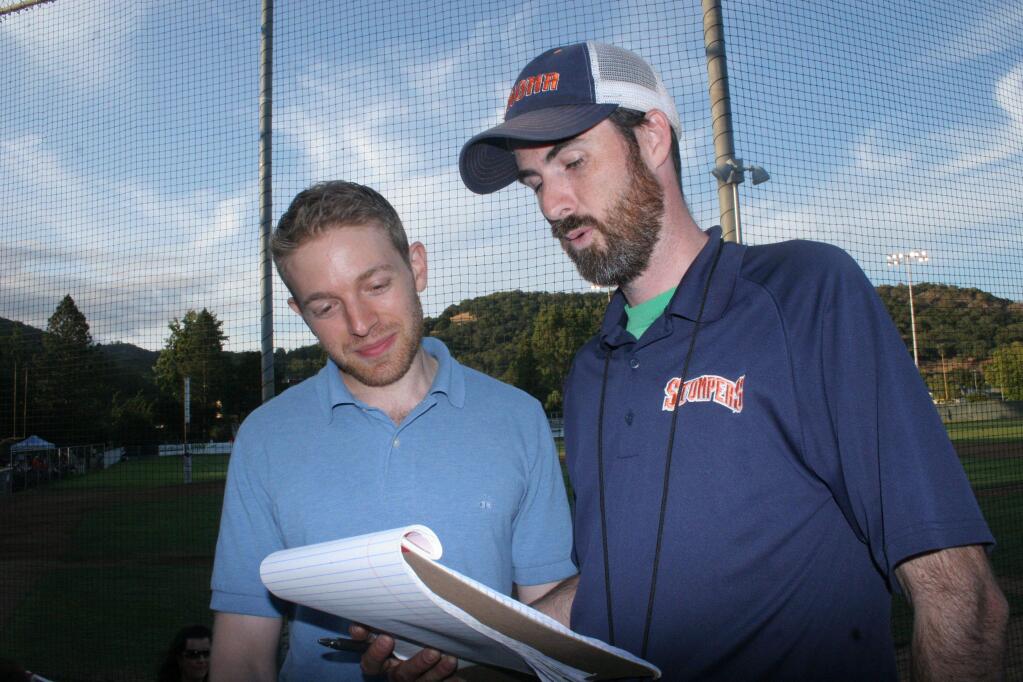 Ben Lindbergh (left) and Sam Miller compare player statistics prior to a Stompers home game during the 2015 season. Their book about the experience, 'The Only Rule Is it Has to Work,' was published this spring. (Christian Kallen/Index-Tribune)