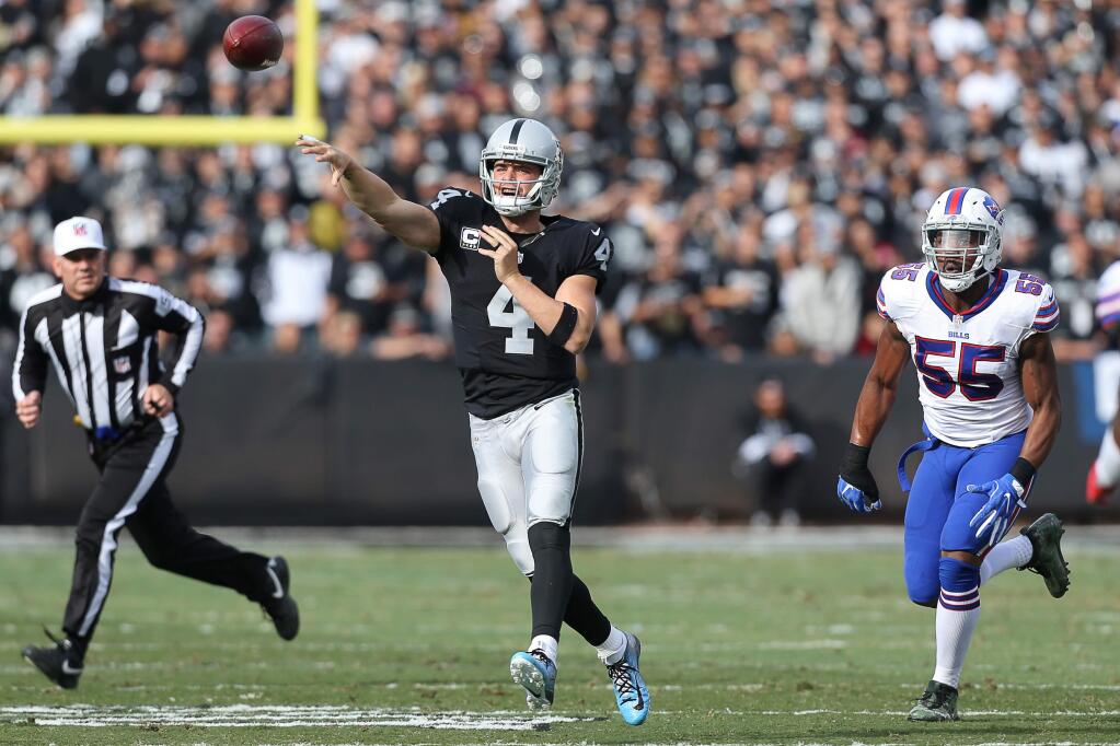Oakland Raiders quarterback Derek Carr throws a pass against the Buffalo Bills during their game in Oakland on Sunday, December 4, 2016. The Raiders defeated the Panthers 38-24. (Christopher Chung / The Press Democrat)