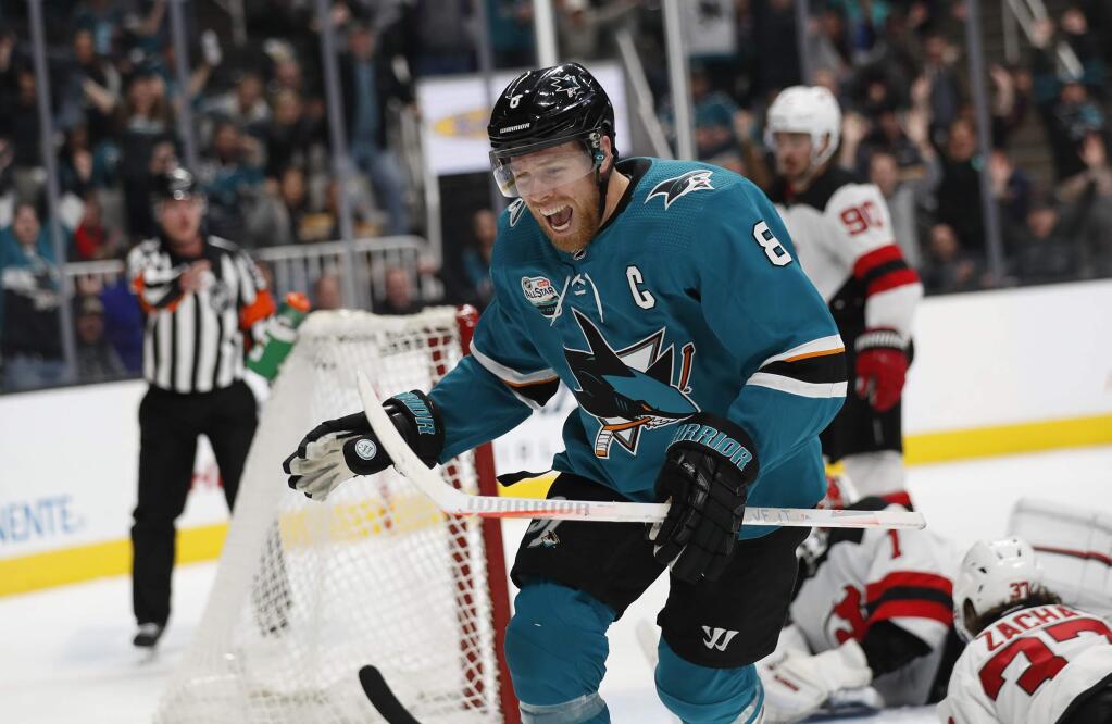 San Jose Sharks' Joe Pavelski (8) celebrates after scoring goal against the New Jersey Devils goaltender Keith Kinkaid (1) in the first period of an NHL hockey game in San Jose, Calif., Monday, Dec. 10, 2018. (AP Photo/Josie Lepe)