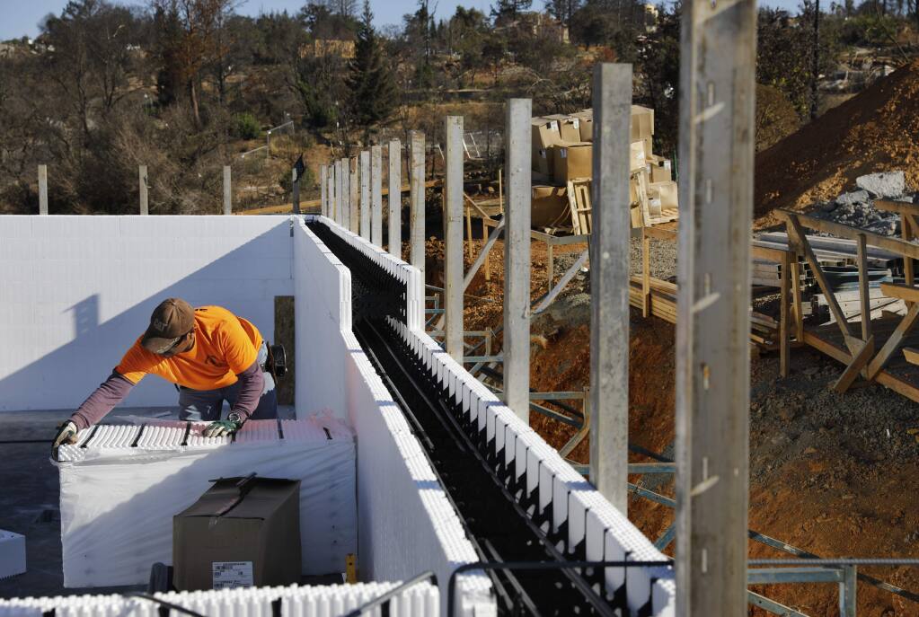 Felix Aguilar installs forms made of polystyrene foam as part of the IntegraSpec building system. The forms will be filled with rebar and concrete. Photo taken in the Fountaingrove area of Santa Rosa on Thursday, September 20, 2018. (Beth Schlanker/ The Press Democrat)