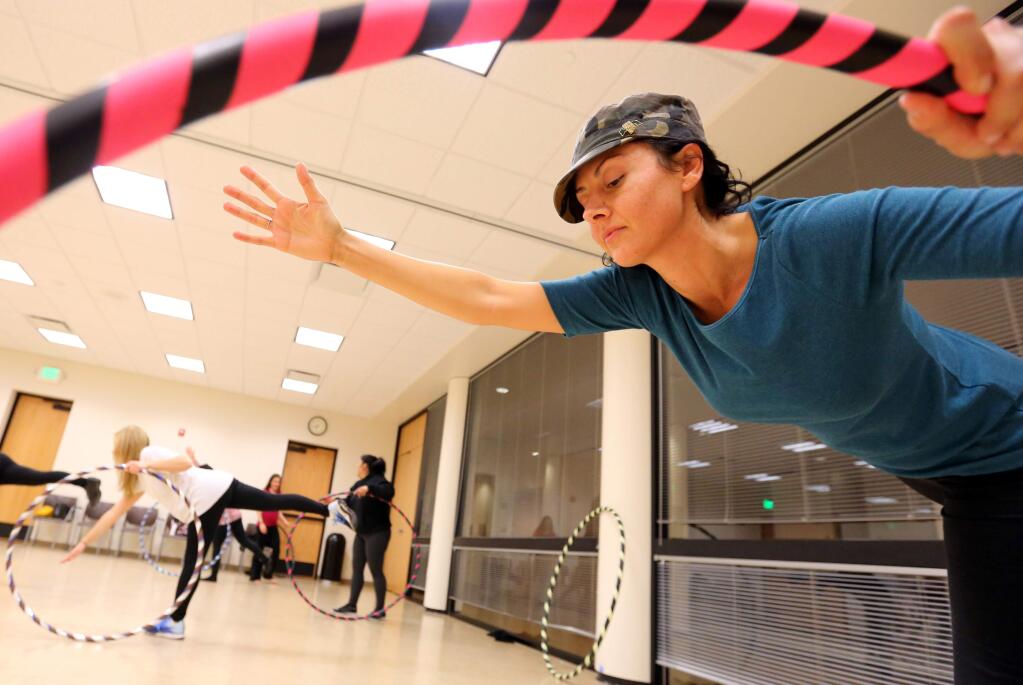 PHOTO: 2 BY CRISTA JEREMIASON/ THE PRESS DEMOCRAT -Jessie Parker stretches during a hula hoop dance fitness class in the Person Senior Wing of the Finley Community Center in Santa Rosa on Monday.