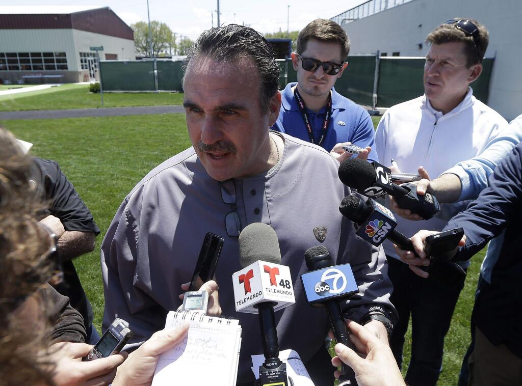 49ers head coach Jim Tomsula faces the usual barrage of questions and a battery of microphones, cameras and notebooks. Is being the head coach one of the most stressful coaching jobs on any NFL staff? (Jeff Chiu / Associated Press)