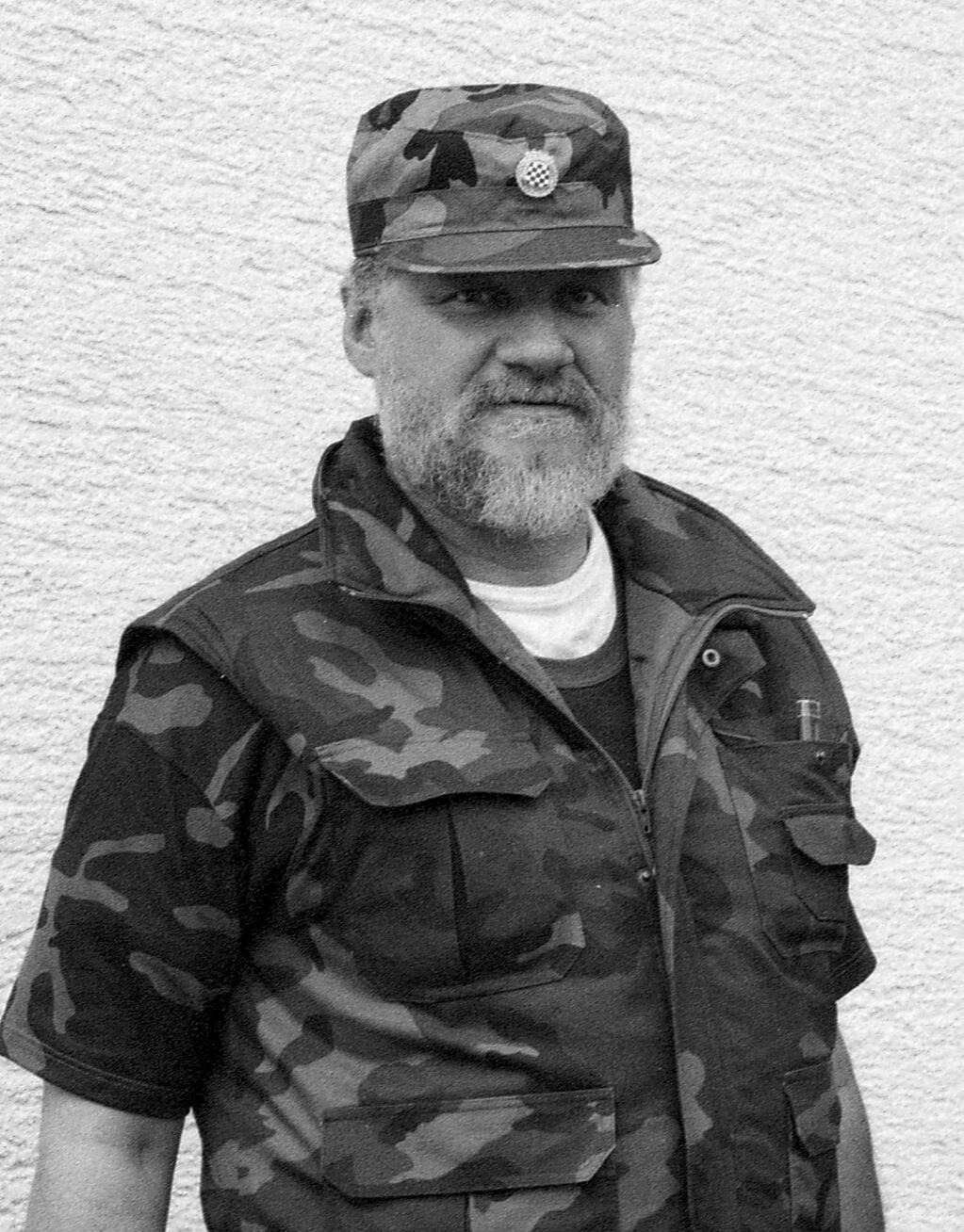 In this Sept. 1991 photo, Slobodan Praljak poses near a front-line in Sunja, Croatia. Slobodan Praljak stunned the International Criminal Tribunal for the former Yugoslavia on Wednesday, Nov. 29, 2017, when he gulped down liquid from a small bottle seconds after a U.N. appeals judge had confirmed a 20-year sentence against him. Praljak was convicted in 2013 of crimes including murder, persecution and deportation for his role in a plan to carve out a Bosnian Croat ministate in Bosnia in the early 1990s. (AP Photo/Darko Bandic)