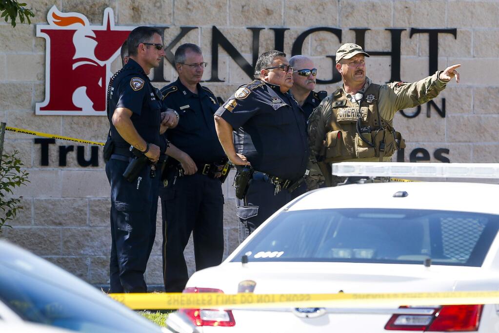 Sheriff's deputies surround Knight Transportation after an employee, who was recently fired, returned to the business and fatally shot an employee before killing himself, Wednesday, May 4, 2016, in Katy, Texas. (Michael Ciaglo/Houston Chronicle via AP)