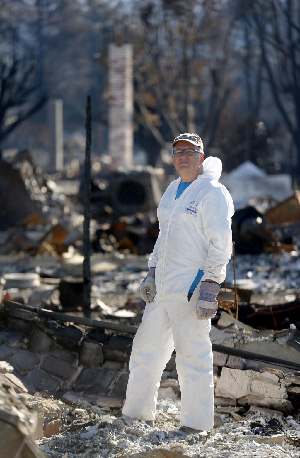 Cartoonist Brian Fies poses for a portrait while looking through the rubble of his home in Mark West Estates in the Larkfield-Wikiup area of Santa Rosa, on Wednesday, October 25, 2017. (BETH SCHLANKER/ The Press Democrat)