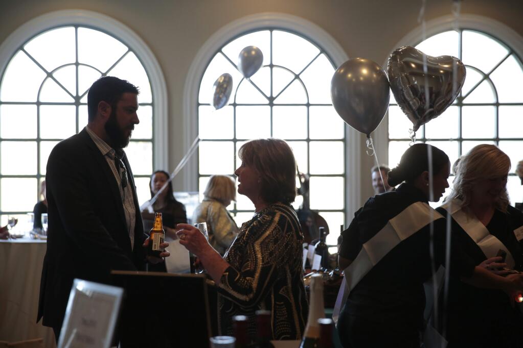 Guests attend the silent auction of the Hearts for Justice Gala, benefiting Legal Aid of Sonoma County at the Santa Rosa Golf and Country Club in Santa Rosa on Saturday, March 23, 2019. (Ramin Rahimian for The Press Democrat)