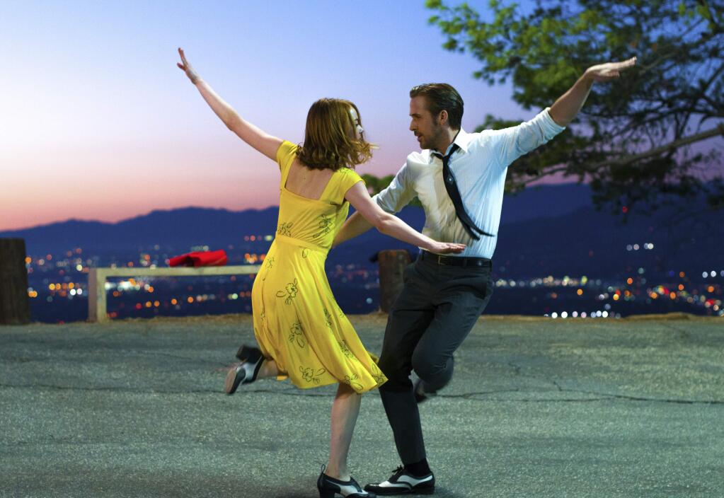This image released by Lionsgate shows Ryan Gosling, right, and Emma Stone in a scene from, 'La La Land.' (Dale Robinette/Lionsgate via AP)
