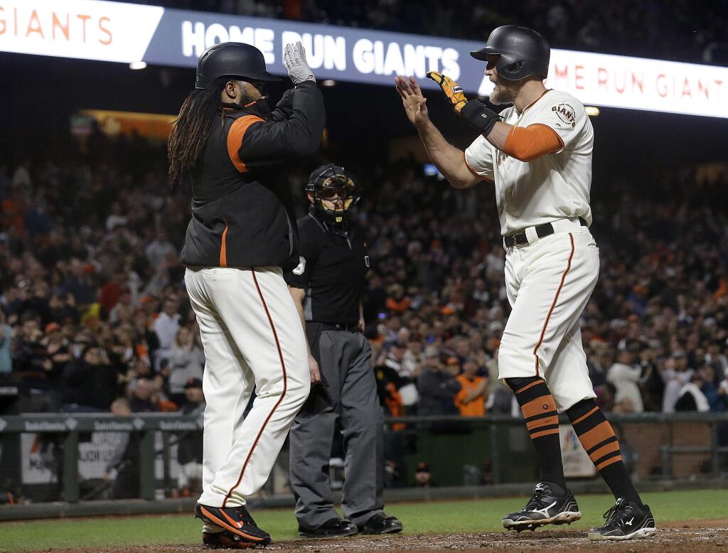 San Francisco Giants' Hunter Pence, right, is congratulated after hitting a two-run home run that scored Johnny Cueto, left, against the Colorado Rockies during the fifth inning of a baseball game in San Francisco, Tuesday, Sept. 19, 2017. (AP Photo/Jeff Chiu)