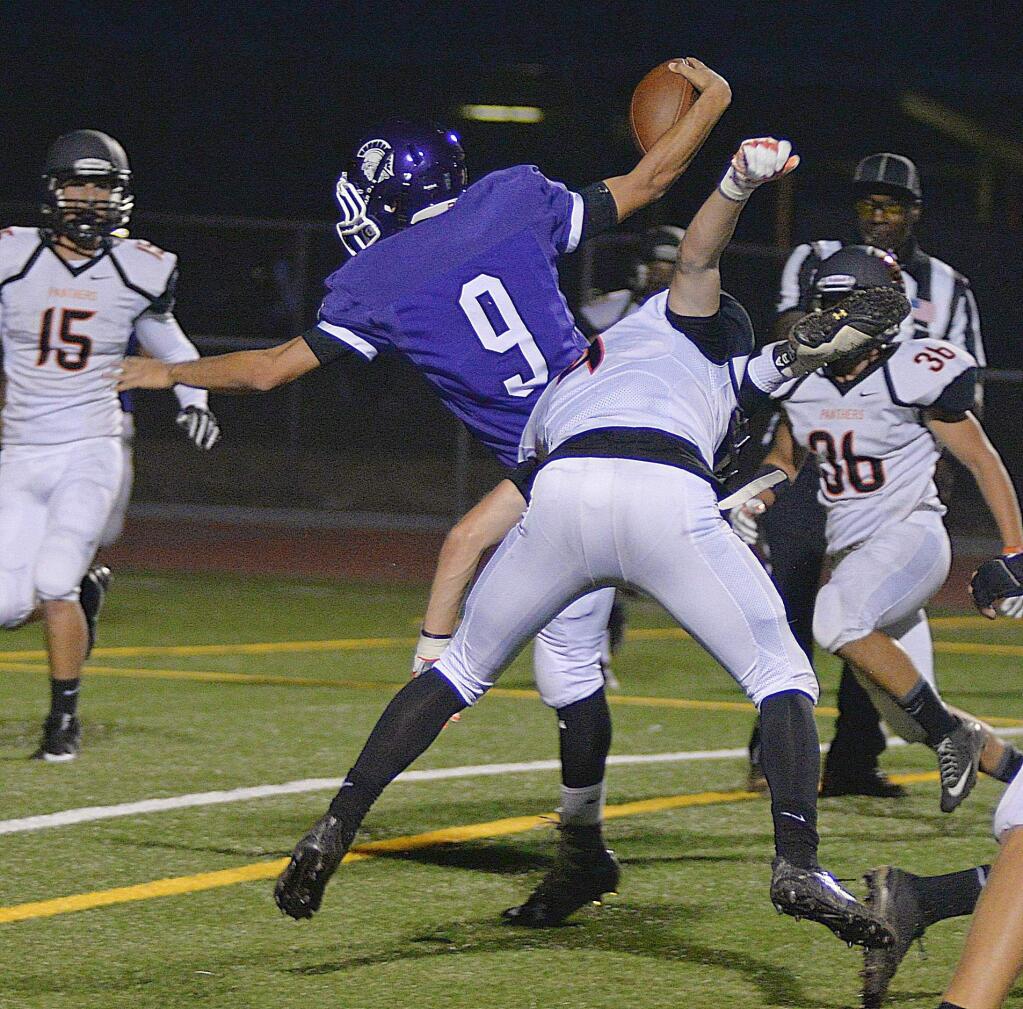 SUMNER FOWLER/FOR THE ARGUS-COURIERPetaluma quarterback Justin Wolbert reaches across the goal line for a touchdown in the Trojans' 49-12 win over Santa Rosa.