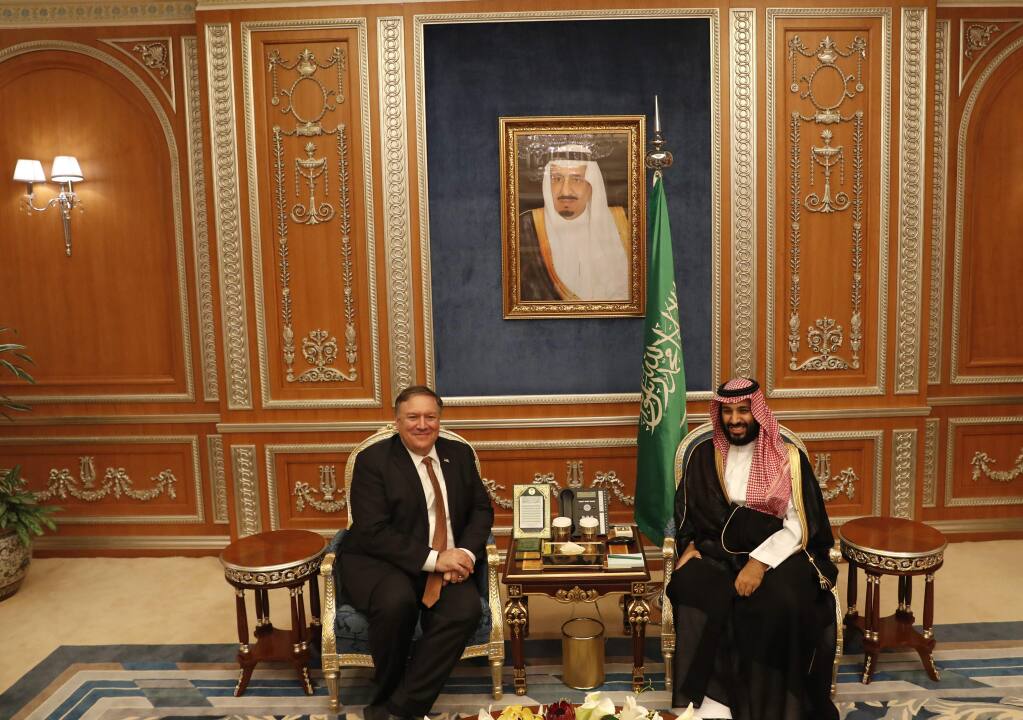 U.S. Secretary of State Mike Pompeo meets with the Saudi Crown Prince Mohammed bin Salman under a portrait of Saudi King Salman, in Riyadh, Saudi Arabia, Tuesday Oct. 16, 2018. Pompeo also met on Tuesday with the king over the disappearance and alleged slaying of Saudi writer Jamal Khashoggi, who vanished two weeks ago during a visit to the Saudi Consulate in Istanbul. (Leah Millis/Pool via AP)