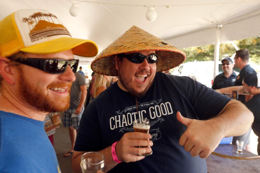 James Graham, right, and Michael Lynwood attend Beerfest – The Good One, a fundraiser for Face to Face at Luther Burbank Center for the Arts in Santa Rosa, California on Saturday, June 11, 2016. (Alvin Jornada / The Press Democrat)