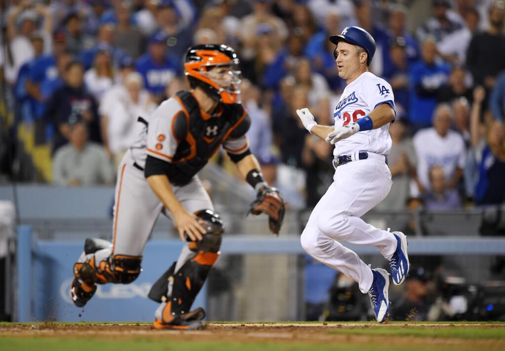 Los Angeles Dodgers' Chase Utley, right, scores as San Francisco Giants catcher Buster Posey waits for a late throw during the sixth inning of a baseball game, Tuesday, Aug. 23, 2016, in Los Angeles. (AP Photo/Mark J. Terrill)