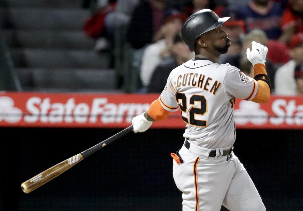 The San Francisco Giants' Andrew McCutchen watches his three-run home run against the Los Angeles Angels during the fifth inning in Anaheim, Friday, April 20, 2018. (AP Photo/Chris Carlson)