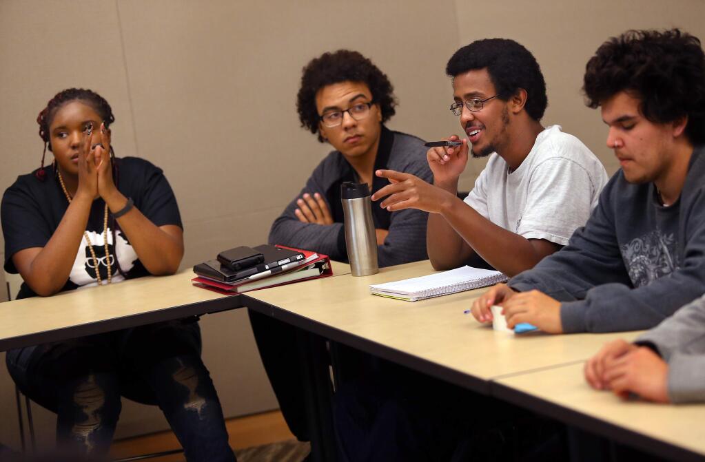 PHOTO: 1 BY CHRISTOPHER CHUNG/ THE PRESS DEMOCRAT -Elias Hinit, second from right, along with Christin Bearden, left, Isaiah Barron and Steven Covarrubias, talk during a joint meeting between the Black Student Union and MECHA at Santa Rosa Junior College.
