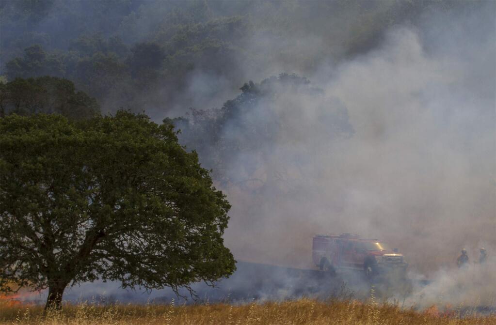 Firefighters used a drip torch to ignite 17.5 acres of grass at the Bouverie Preserve in Glen Ellen on Tuesday, May 30, 2017. More than two dozen firefighters from Cal Fire and Sonoma County fire departments participated in a controlled burn conducted by Audubon Canyon Ranch, in order to reduce build-up of non-native grasses and restore ecosystem health. (Photo by Robbi Pengelly/Index-Tribune)
