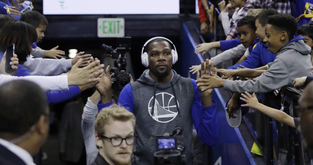 Golden State Warriors' Kevin Durant is greeted by fans as he comes out for warmups before the team's NBA basketball game against the New Orleans Pelicans on Saturday, April 8, 2017, in Oakland, Calif. (AP Photo/Marcio Jose Sanchez)